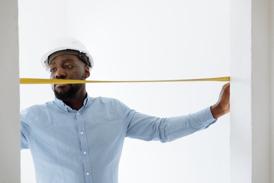 Professional contractor measuring and installing a replacement window